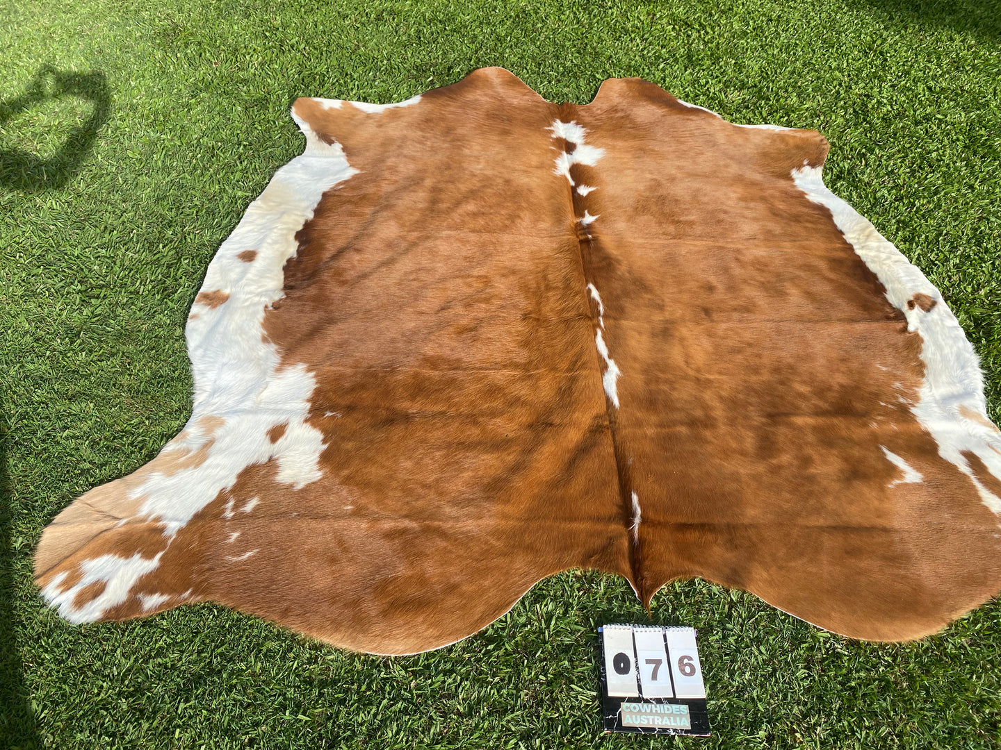 76. Brown white Cowhide