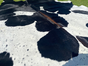 a106. Black white reddish  Cowhide